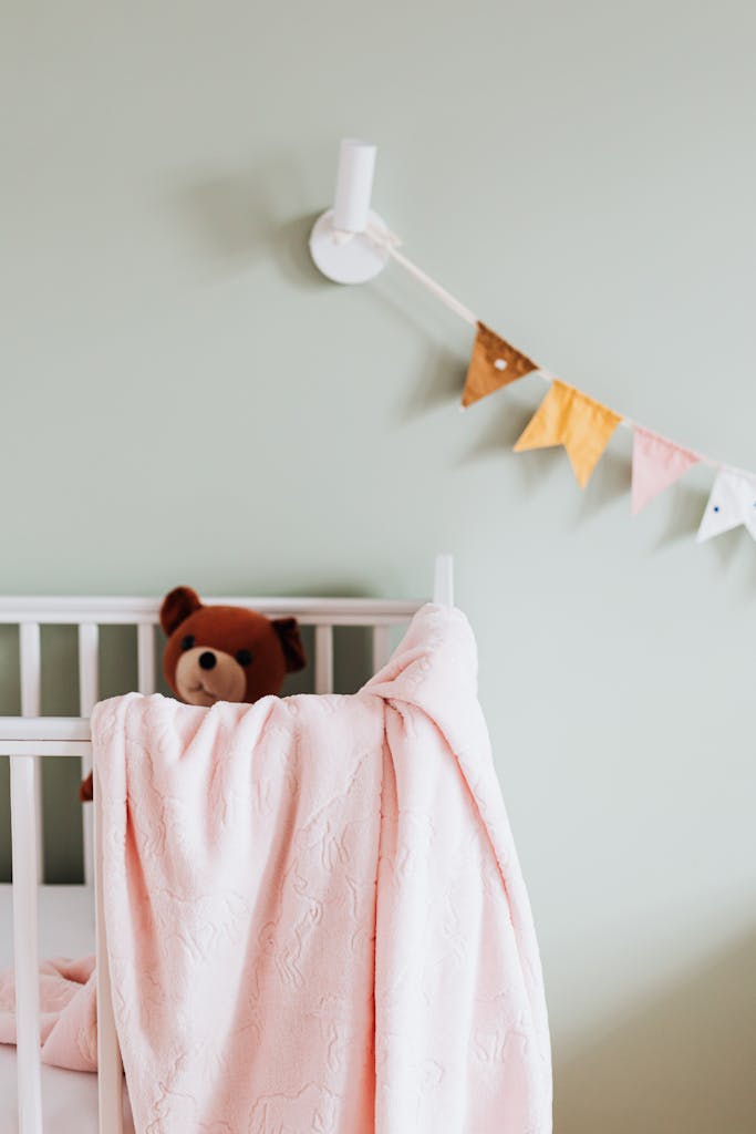 Teddy Bear in Cradle in Nursery